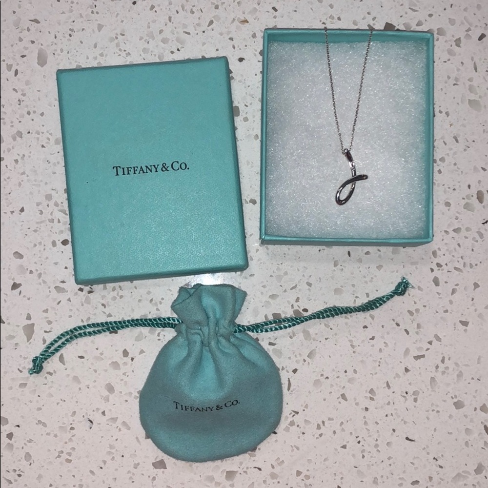 Tiffany & Co. “J” pendant by Elsa Peretti.